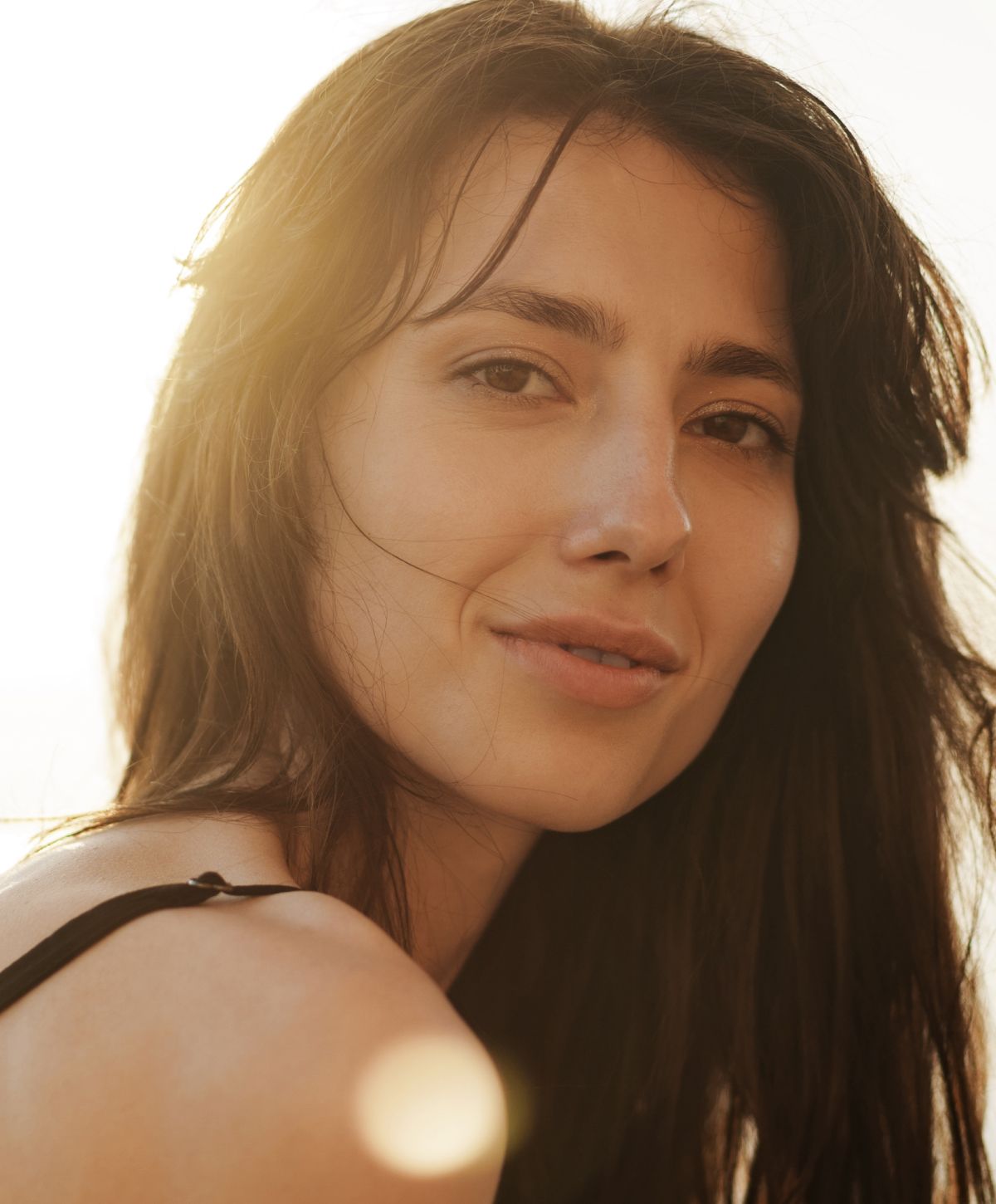 Portrait of a smiling female doctor in white coat.