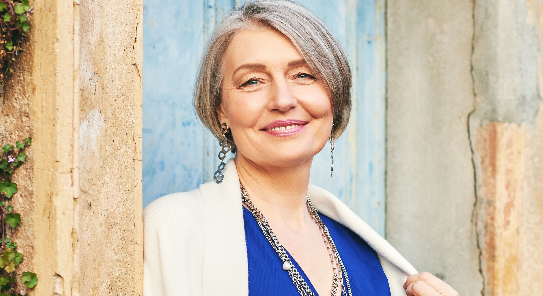 Woman smiling while looking in mirror.