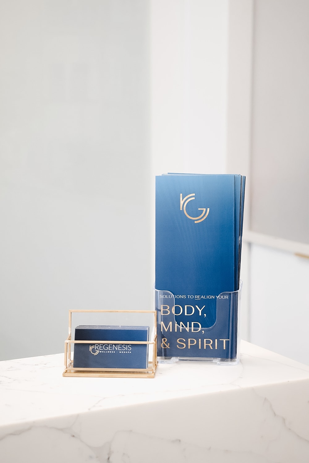 Wellness brochures and business card display on marble.