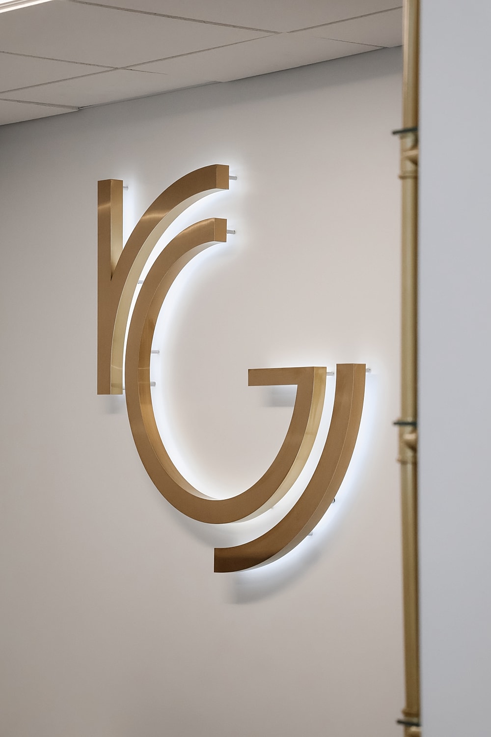 Gold abstract wall art with backlighting.
