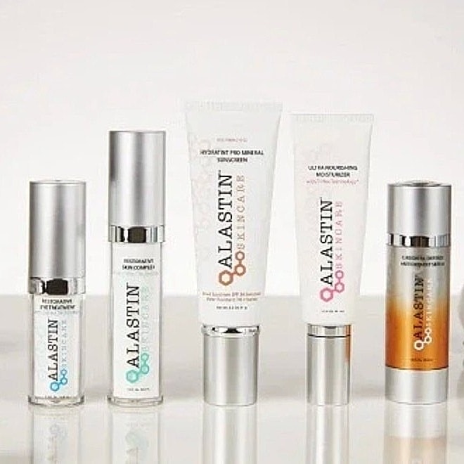 Alastin skincare products displayed on a table.